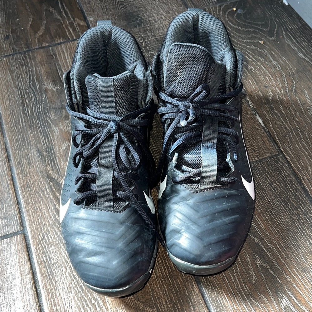 Nike  Alpha Black Cleats with White Swoosh.